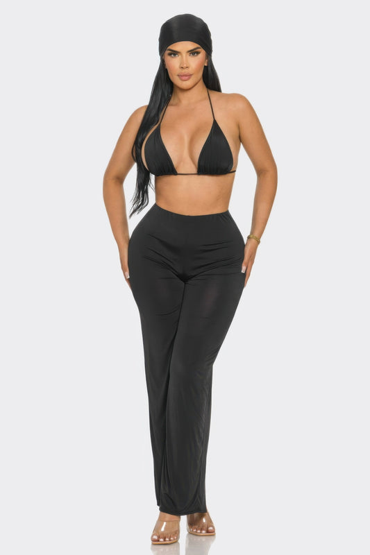 Model showcasing the three piece day to day outfit including a black bra top, wide-leg pants, and matching bandana.