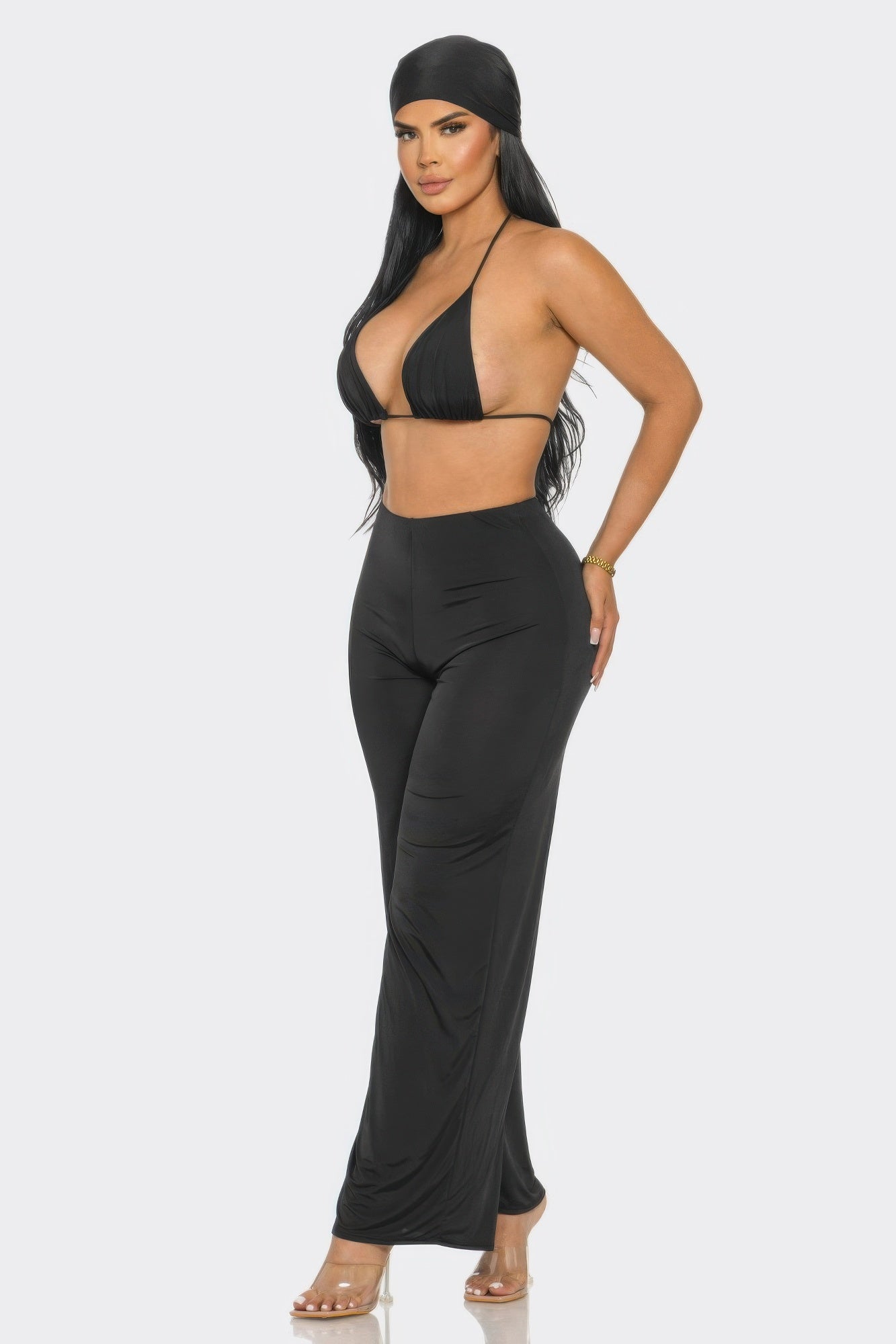 Model showcasing a three piece day to day outfit featuring a bra top, high-waisted pants, and matching bandana.