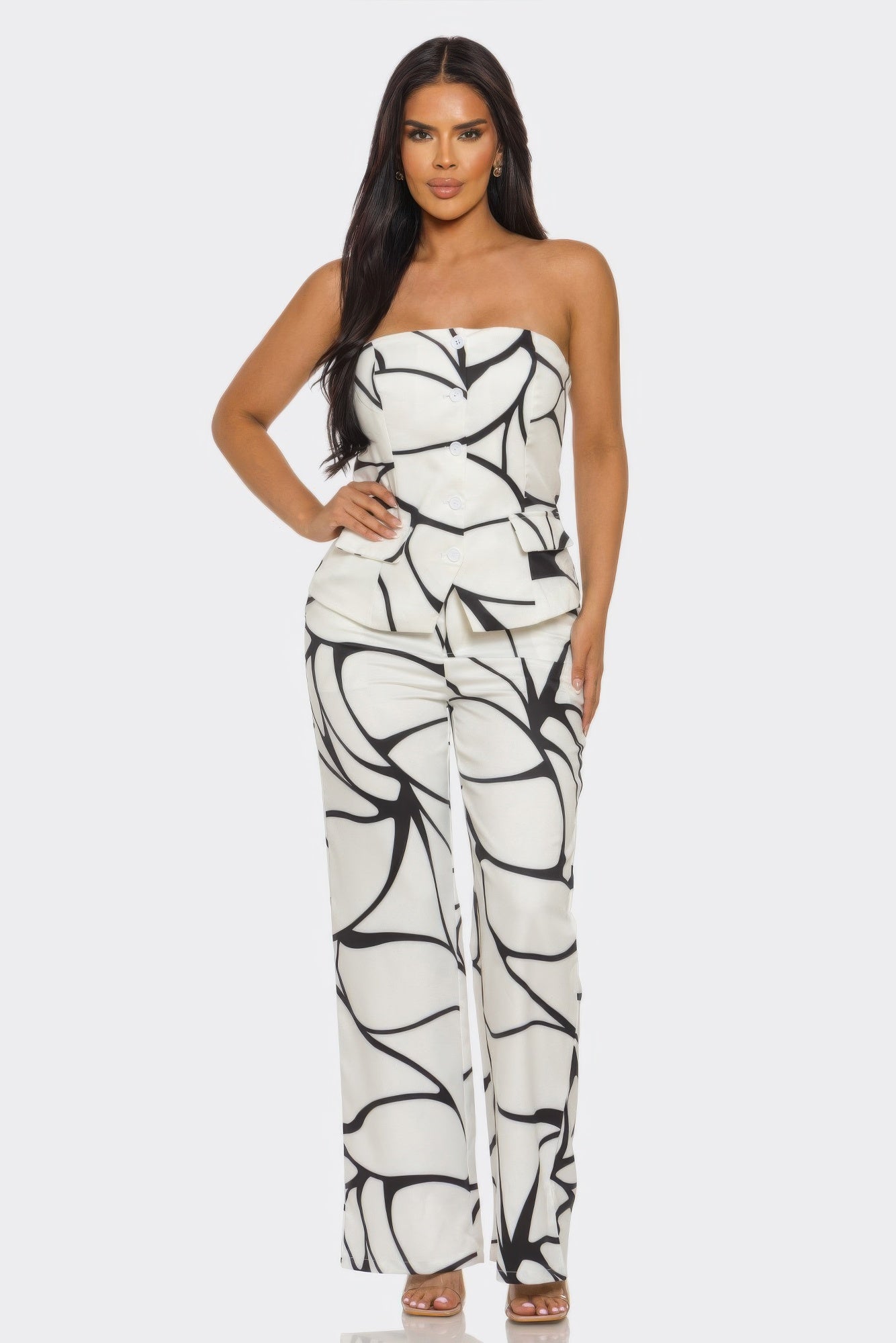 Abstract two-piece set featuring a strapless top and high-waisted wide-leg trousers with artistic patterns.