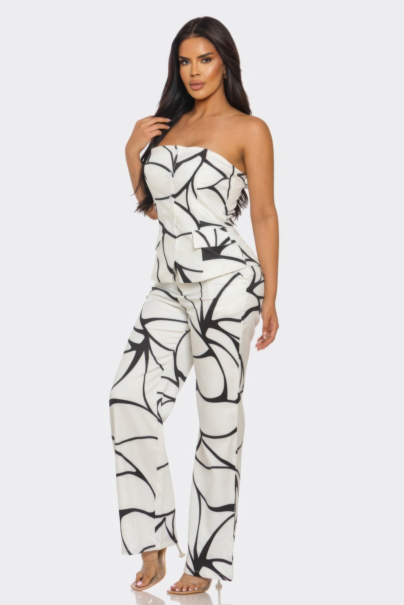 Model showcasing the abstract two-piece set featuring a strapless top and wide-leg trousers in a striking design.