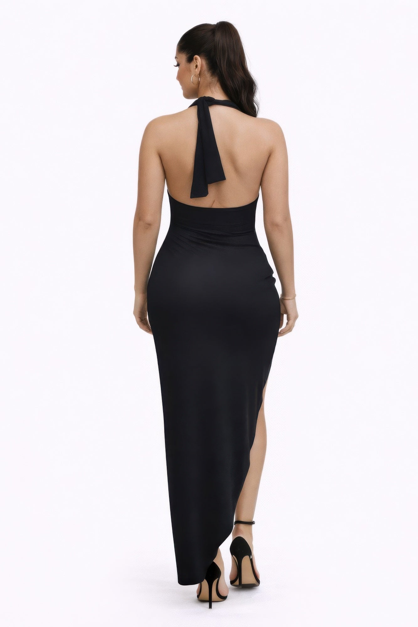 Back view of a woman in a bold statements dress with a multiway neckline and elegant silhouette.