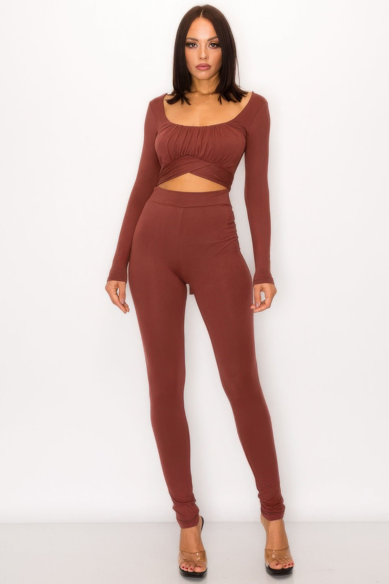 Model wearing a tie back cutout jumpsuit featuring front shirring and back tie detail in a sophisticated design.