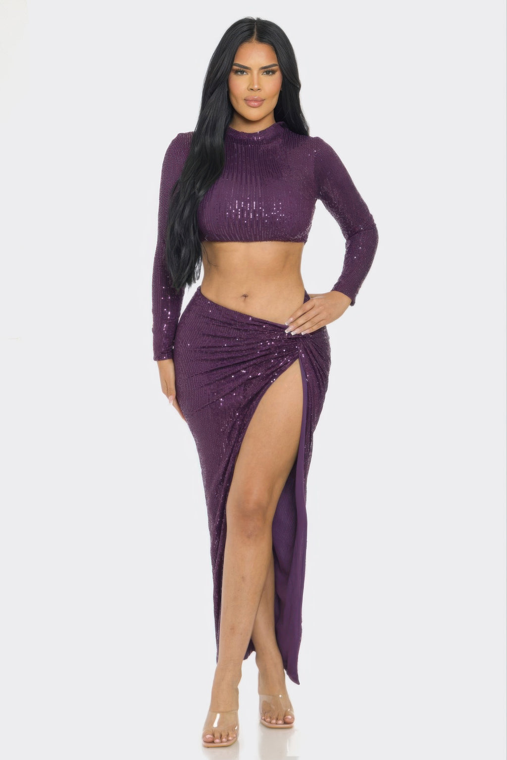 Model wearing a stylish sequin two-piece set with long sleeve top and twist front skirt.