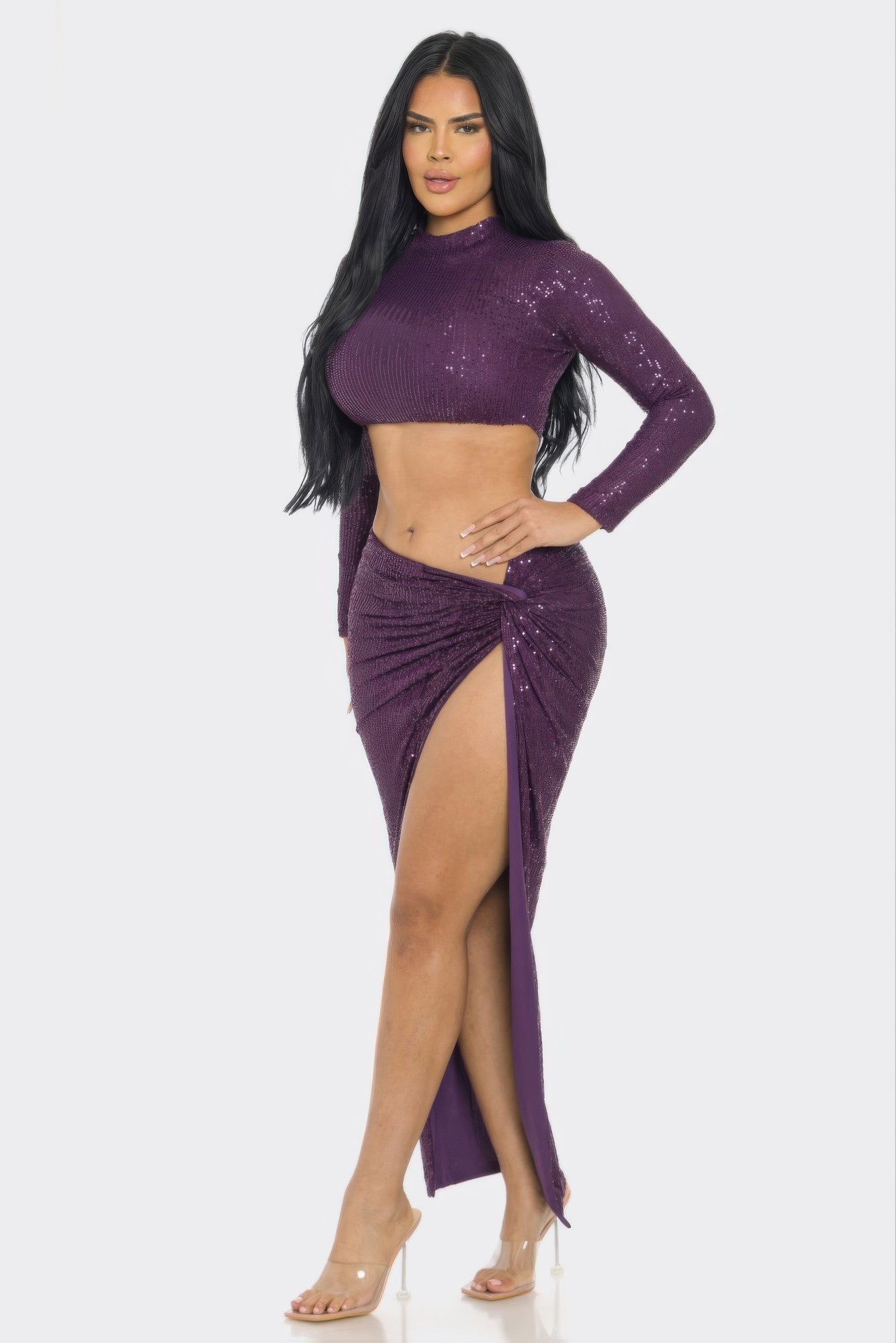 Sequin two-piece set featuring a long sleeve crop top and high-slit skirt in a striking purple color.