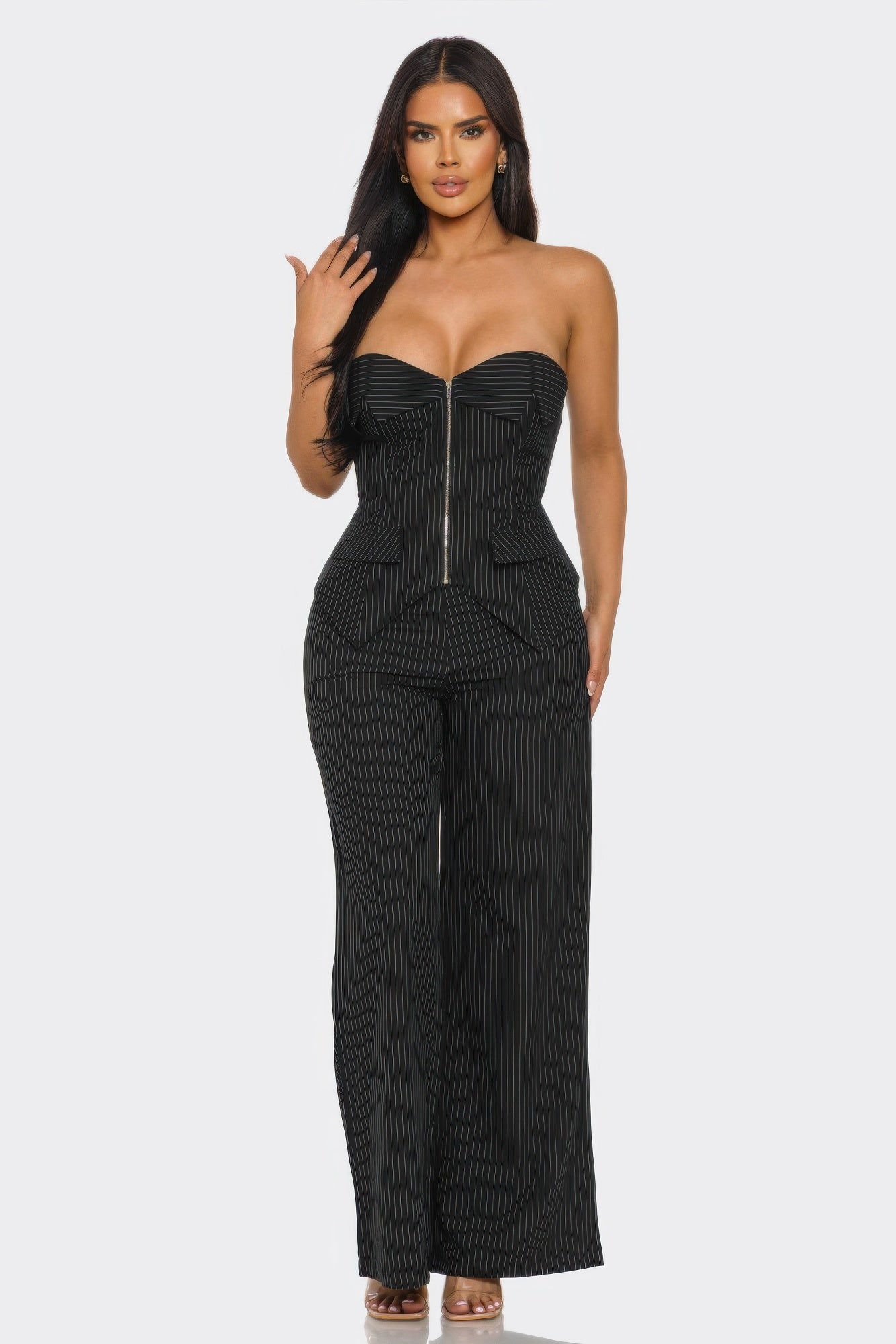 Model wearing a strapless power structure set featuring a corset top and wide-leg trousers.
