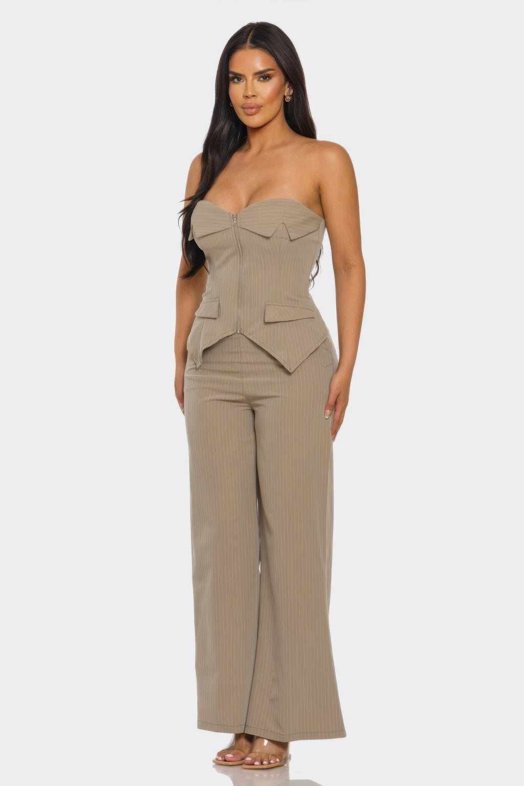 Woman wearing a strapless power structure set with structured corset top and wide-leg trousers.