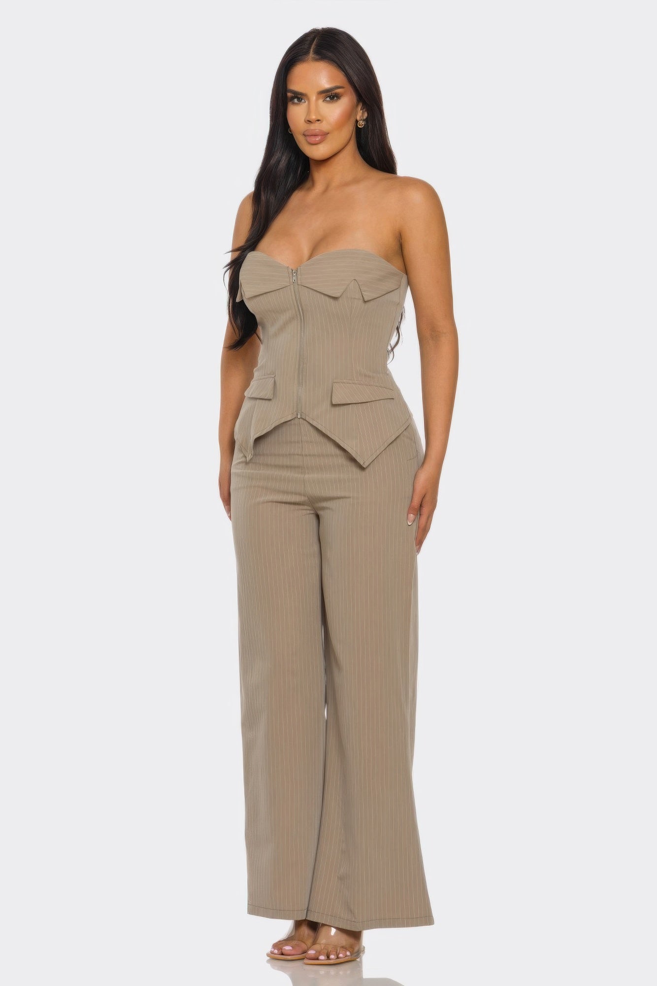 Woman wearing a strapless power structure set with structured corset top and wide-leg trousers.
