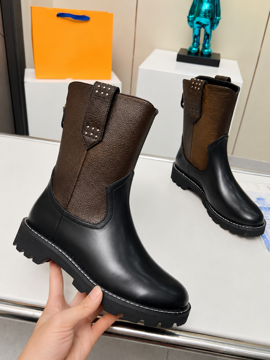 Stylish monogram combat boots with a chunky sole, perfect for streetwear fashion.