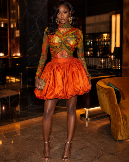Floral crop top and bubble mini skirt set featuring a vibrant twist-front crop top and voluminous orange mini skirt.