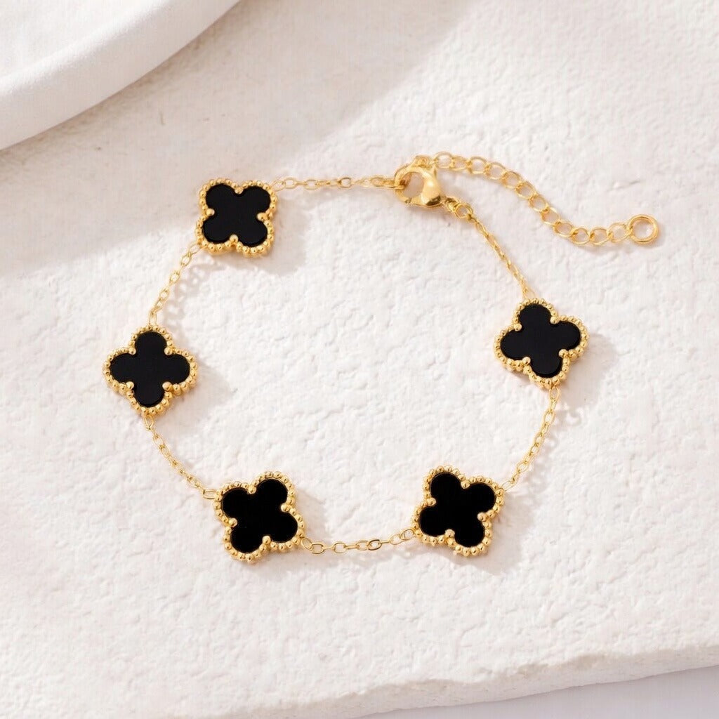 14K gold plated clover bracelet featuring black onyx charms on a delicate chain, perfect for stylish layering.