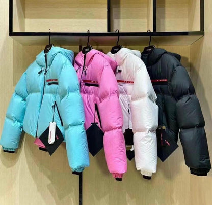 ColorBlock Cropped Puffer Coat with Hood in Sky Blue, Pink, White, and Black, perfect for winter wear.