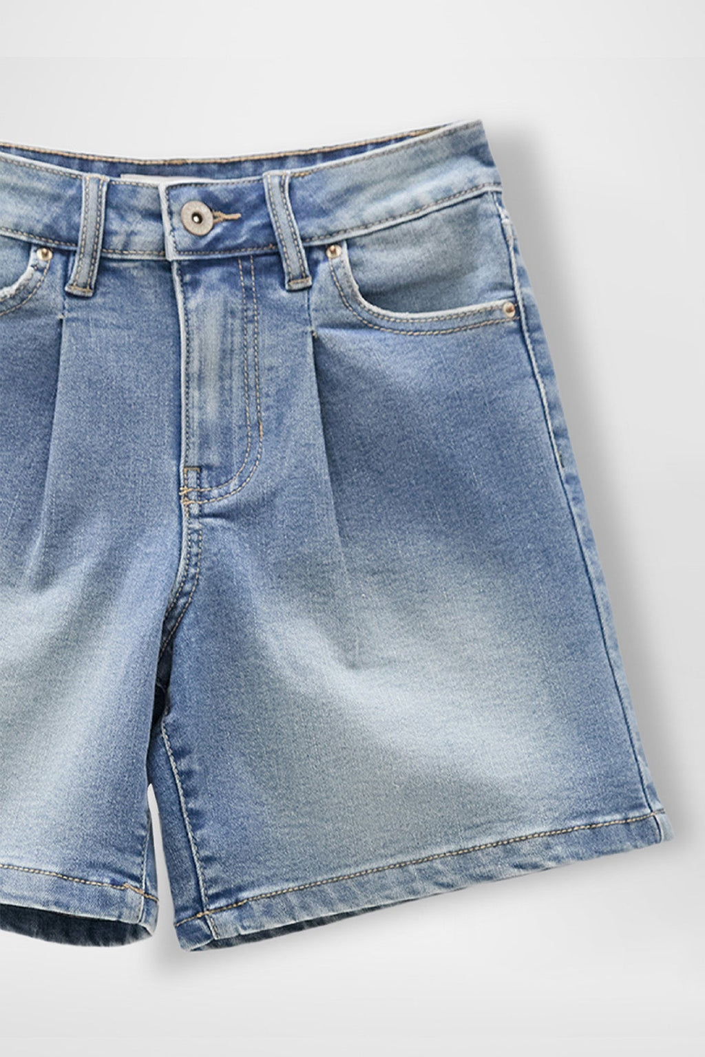 Alt Tag: Close-up of girls front pleat denim jorts showing front pleat, 4-pocket layout, belt loops, and button-and-zip fly