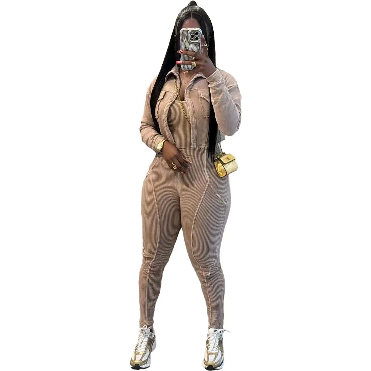 Person wearing a beige ribbed jumpsuit with a white background