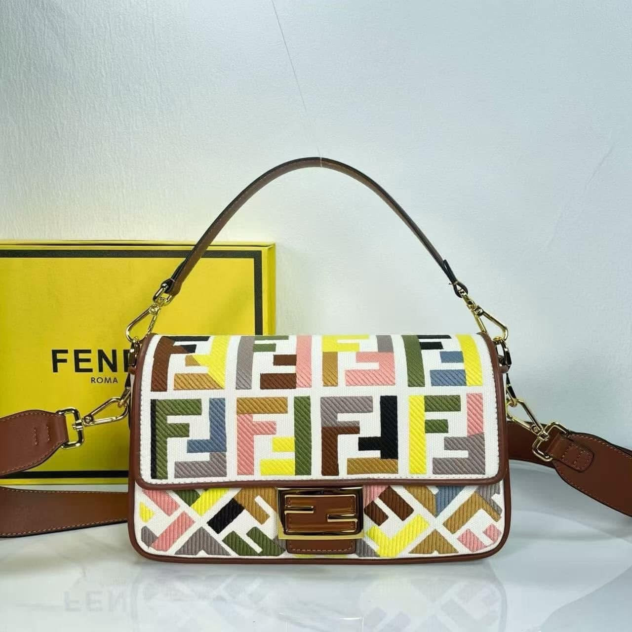 Designer handbag with geometric pattern placed against a white background.