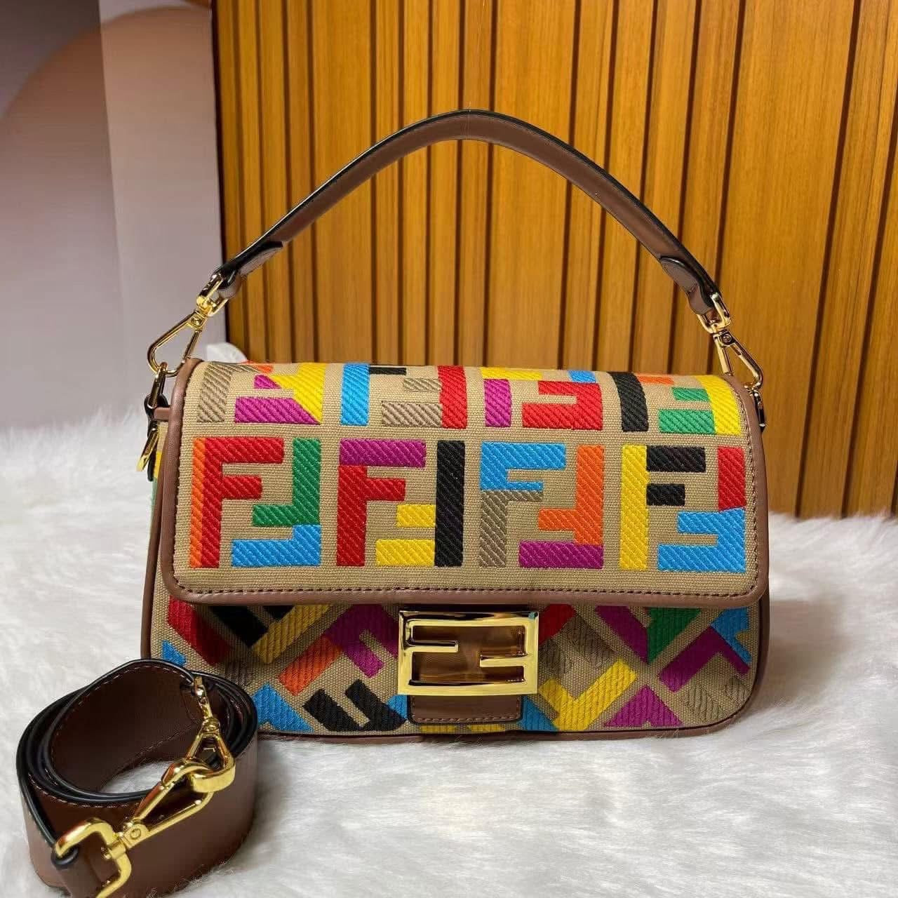 Colorful patterned handbag with gold accents on a white surface