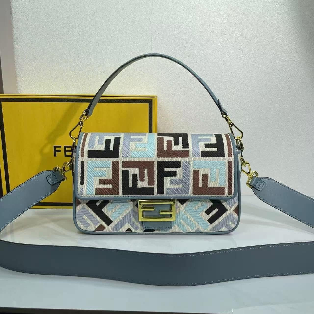 Designer handbag with geometric pattern and visible brand logo on a white background