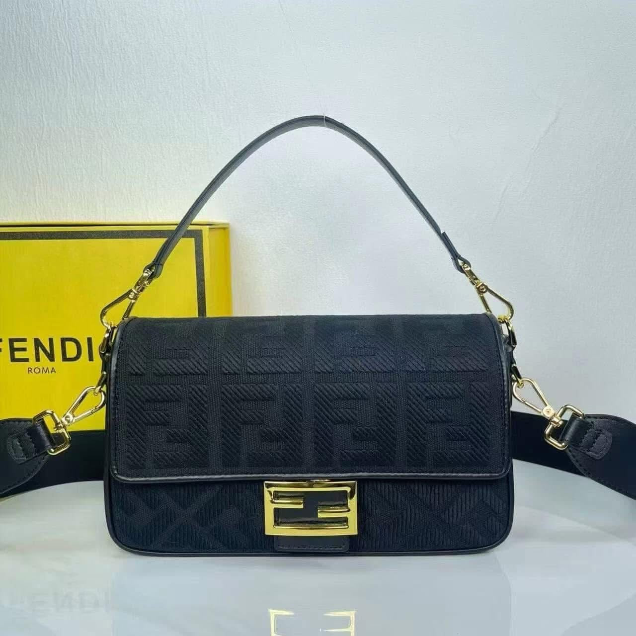 Black handbag with gold accents on a white background.