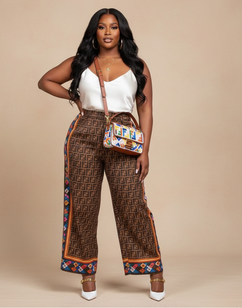 Woman wearing patterned pants and a white top with a colorful handbag on a beige background