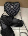 Black heart crossbody set featuring a quilted heart-shaped bag and matching cushioned slides.