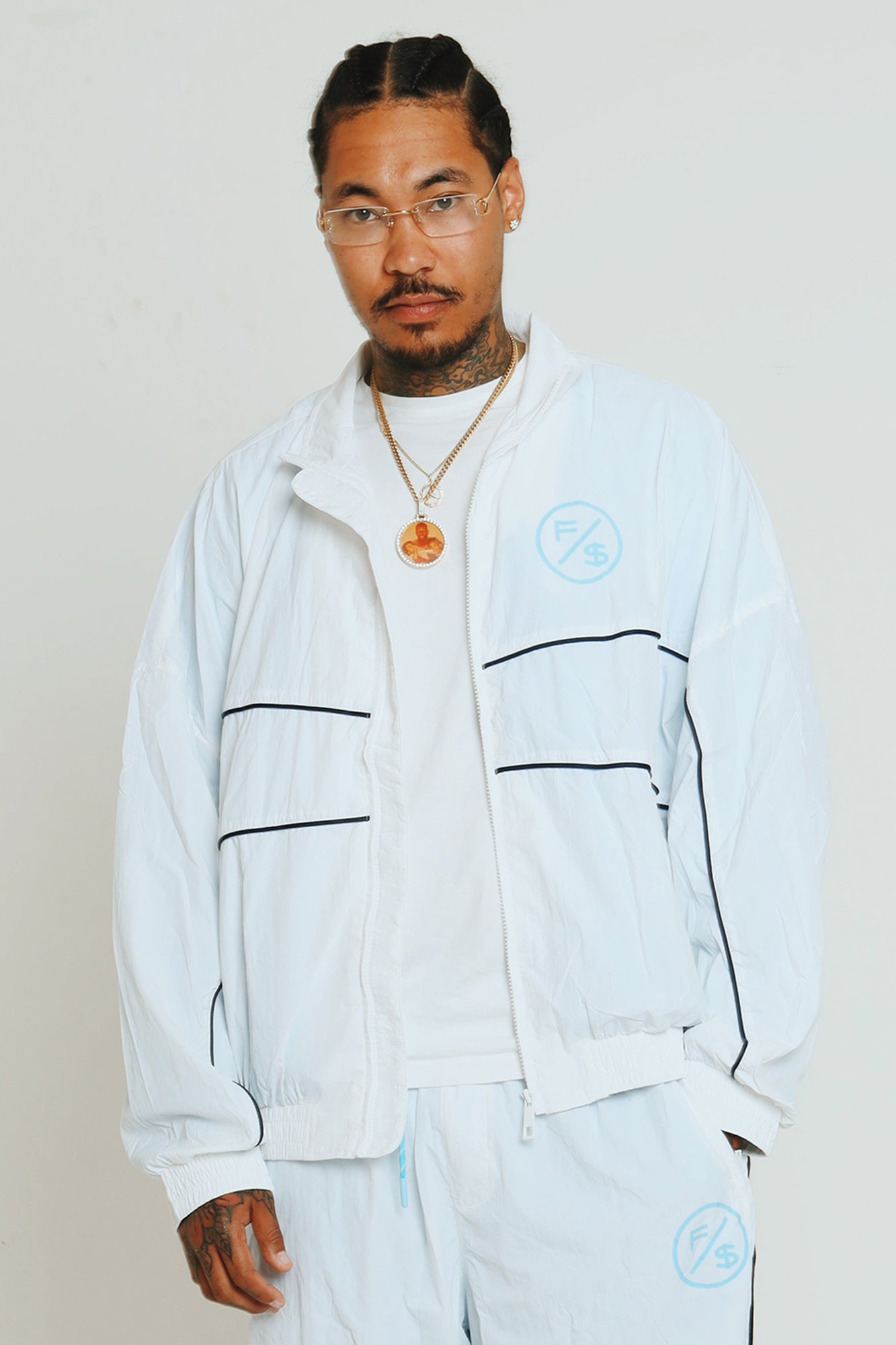 Lightweight utility windbreaker jacket worn by model, showcasing full zip design and modern streetwear style.