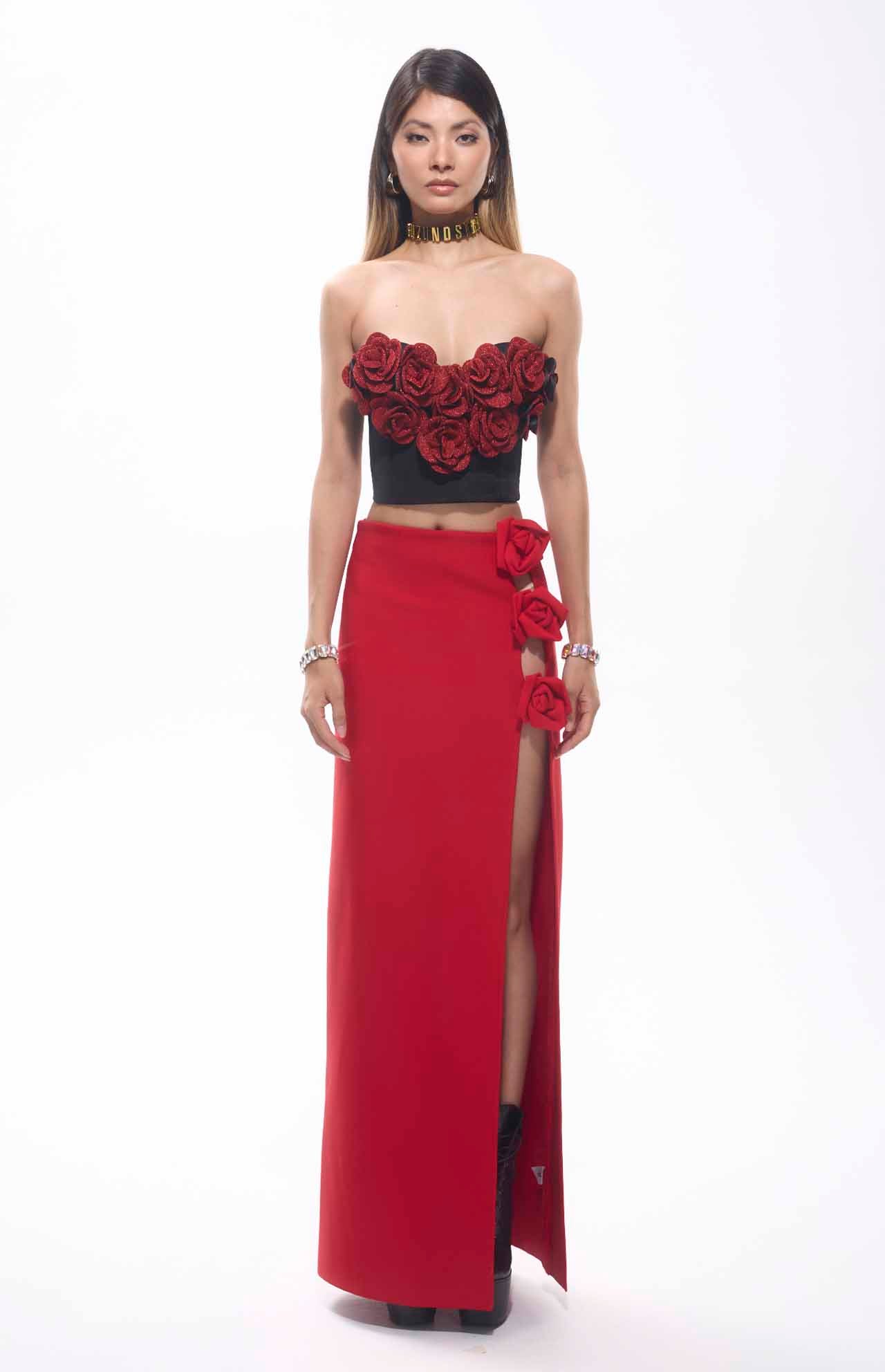 Model wearing a Flower Patch Corset Mini Top with red floral decor and a red skirt, perfect for bold events.