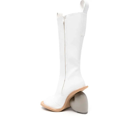 Alt Tag: Heartbreak Heeled Mid-Calf Boots in white microfiber leather with curved heart heel, side zipper, sculptural high-fashion silhouette
