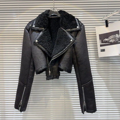 Cropped faux-leather shearling moto jacket featuring a plush collar and bold zippers, designed for winter fashion.