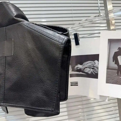 Structured faux leather jacket displayed against a backdrop of fashion photography, showcasing its bold design.