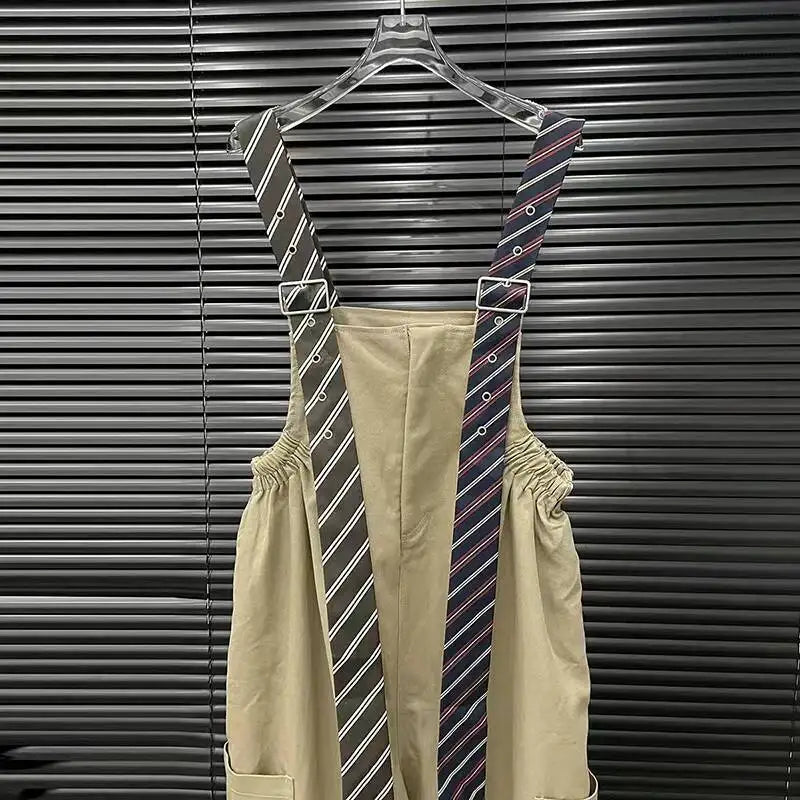 Alt Tag: Executive Street Suspender Jumpsuit with detachable tie-style suspenders on hanger, high-waist wide-leg silhouette in beige polyester