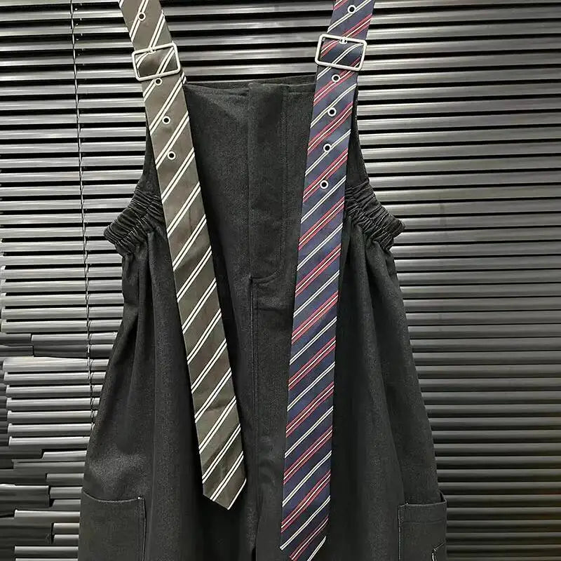 Alt Tag: Executive Street Suspender Jumpsuit black wide-leg high-waist jumpsuit with detachable tie-style suspenders, tailored streetwear look