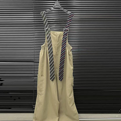 Alt Tag: Executive Street Suspender Jumpsuit with detachable tie-style suspenders, high-waist wide-leg beige fit hanging on hanger