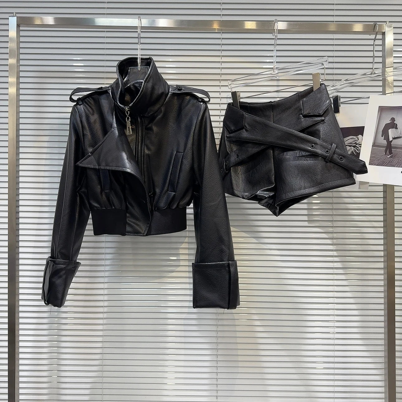 faux leather mini set with jacket and shorts displayed on a hanger with a modern background