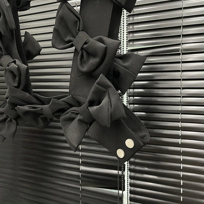 Close-up of the bow cascade crop top showcasing 3D layered bows in black fabric on a stylish background.