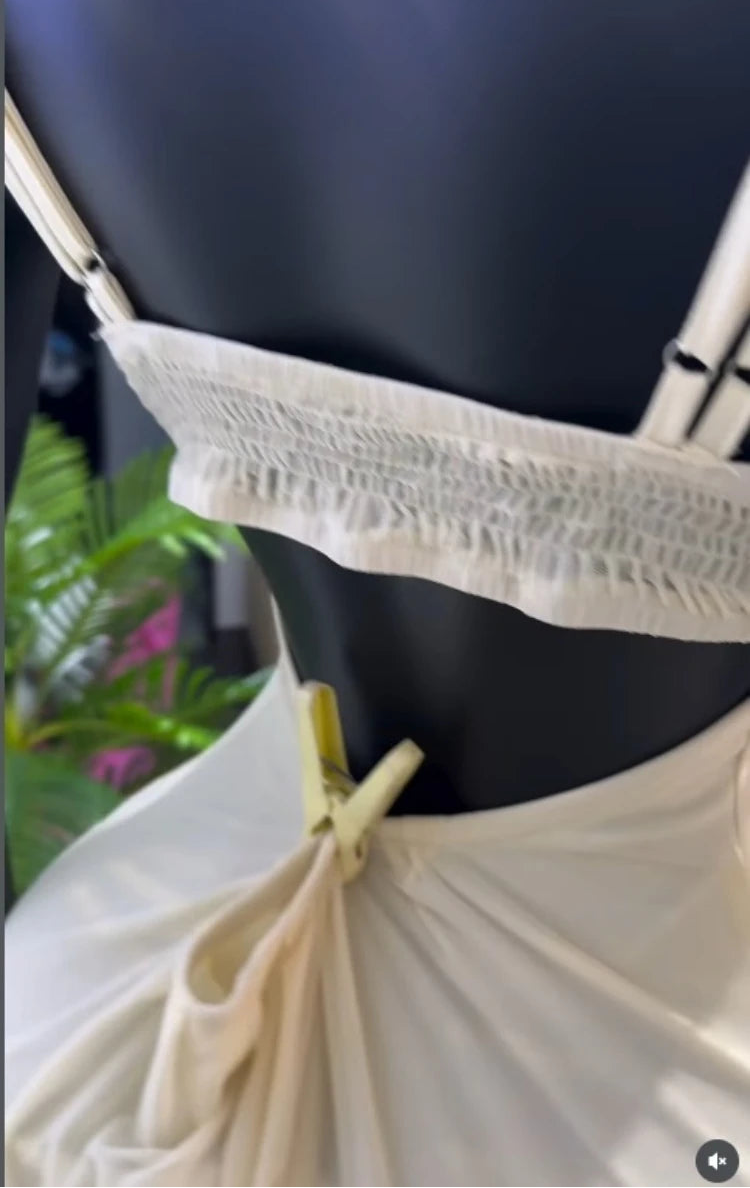 Mannequin wearing a white lace top with a blurred background
