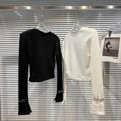 Alt Tag: Asymmetric Zip Sculpt Long-Sleeve Top – Minimalist Streetwear Cutout Tee black and white long-sleeve tops on hangers