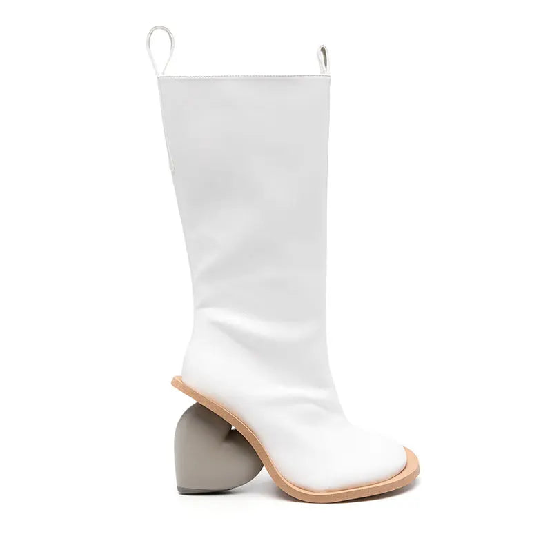 Alt Tag: Heartbreak Heeled Mid-Calf Boots in white microfiber leather with sculptural curved heart heel, runway-inspired women’s statement boots