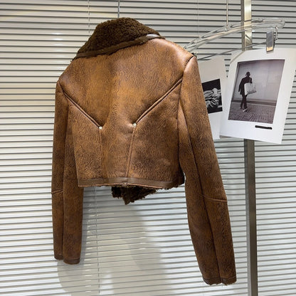Back view of a cropped faux-leather shearling moto jacket showcasing its plush lining and unique detailing.