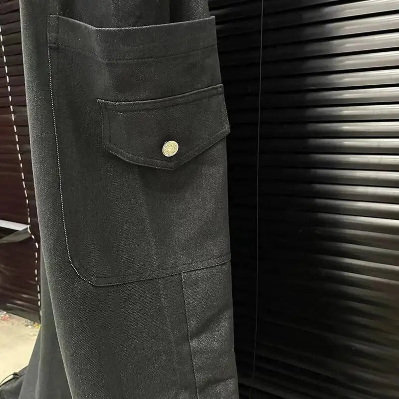 Alt Tag: Executive Street Suspender Jumpsuit black wide-leg pant detail with flap pocket and button, high-waist tailored streetwear style