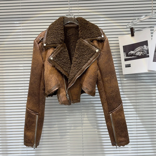 Cropped faux-leather shearling moto jacket in brown with plush lining and bold zipper details on display.