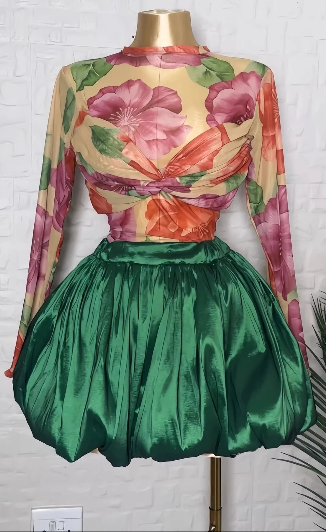 Floral crop top and bubble mini skirt set featuring a colorful twist-front top and voluminous green skirt.
