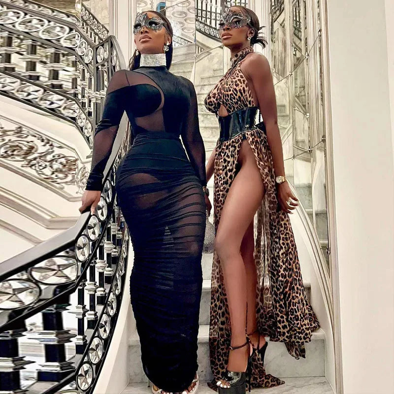 Black Velvet + Mesh Illusion model showcasing the velvet illusion maxi dress set on a grand staircase with elegant decor.
