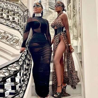 Black Velvet + Mesh Illusion model showcasing the velvet illusion maxi dress set on a grand staircase with elegant decor.