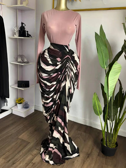 Sculpted Mirage Draped Maxi Dress featuring sculpted pleats and a fitted top in a stylish display.