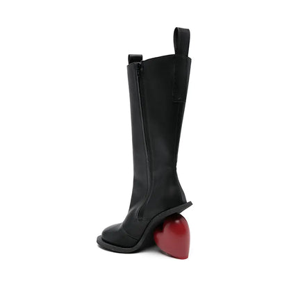 Alt Tag: Heartbreak Heeled Mid-Calf Boots in black microfiber leather with sculptural red heart heel, runway-inspired women’s statement boot