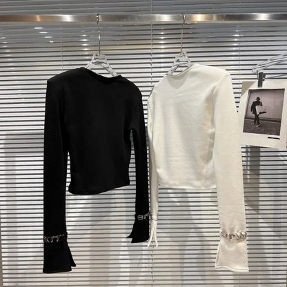 Asymmetric zip streetwear top showcased in black and white, highlighting minimalist design and long sleeves.