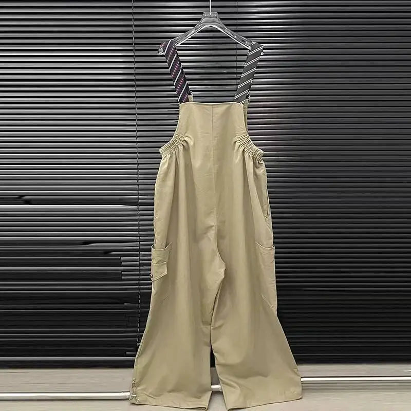Alt Tag: Executive Street Suspender Jumpsuit beige wide-leg high-waist jumpsuit with detachable tie suspenders hanging on hanger