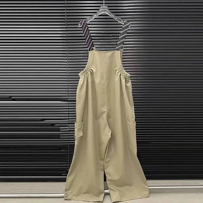 Alt Tag: Executive Street Suspender Jumpsuit beige wide-leg high-waist jumpsuit with detachable tie suspenders hanging on hanger