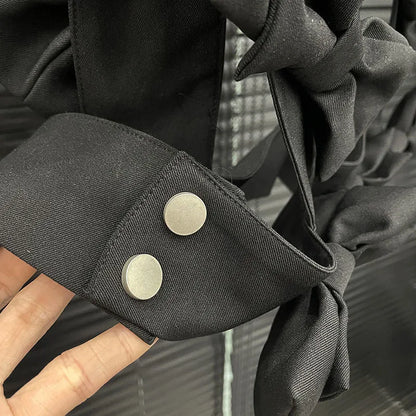 Close-up of the bow cascade crop top showcasing layered 3D bows and silver button details.