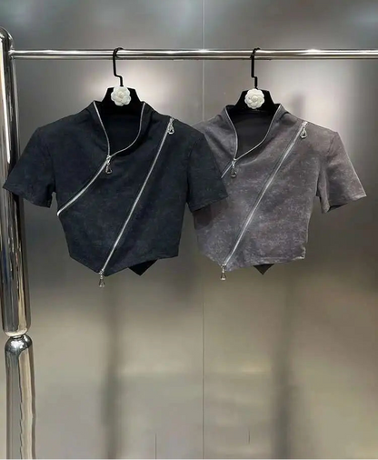 Asymmetrical zip crop top displayed in black and gray, featuring a diagonal zipper and sculpted hem.