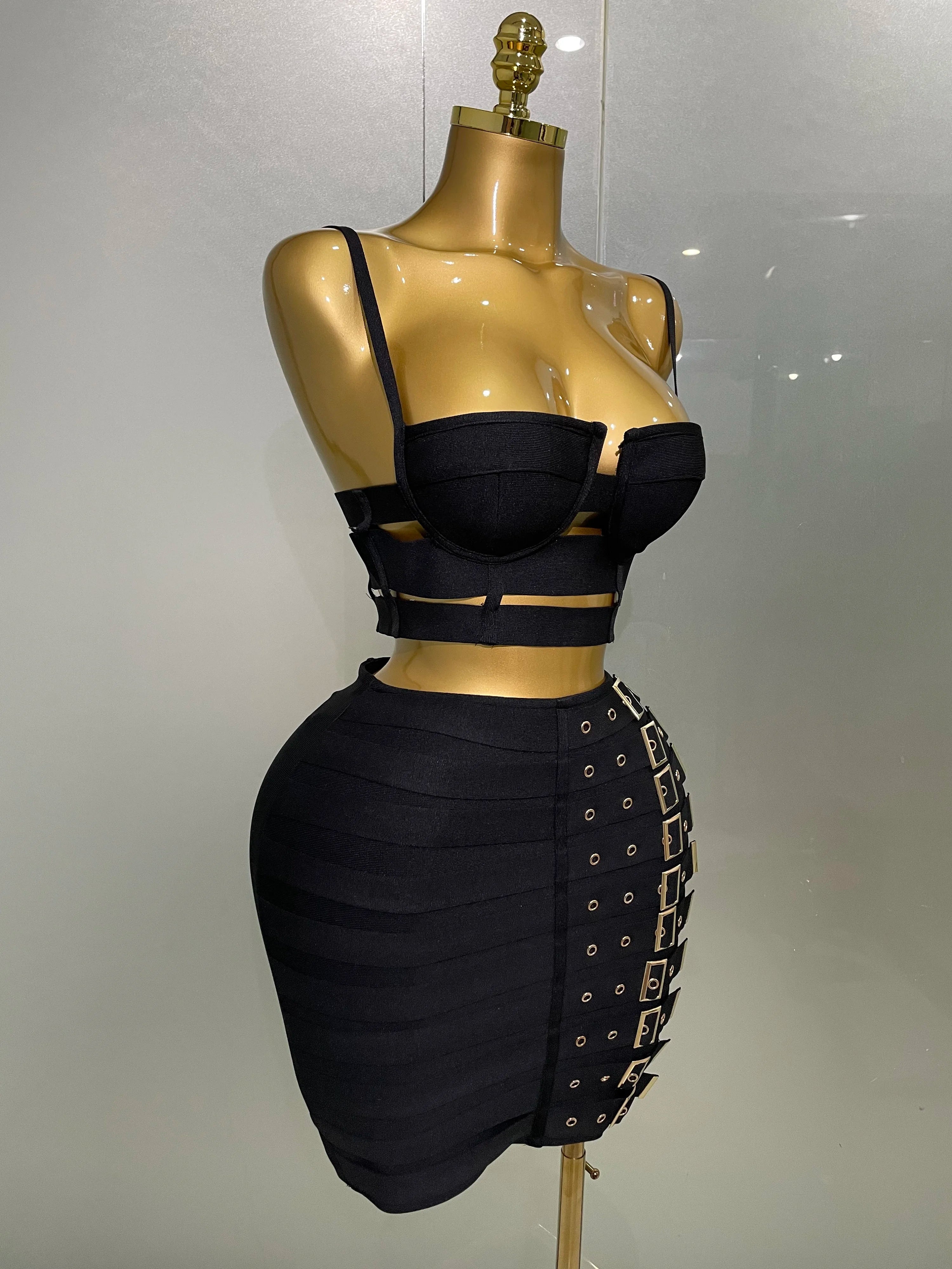 Sculpted Buckle Bandage 2-Piece Set black bandage bustier crop top and high-waist skirt with buckle details on mannequin